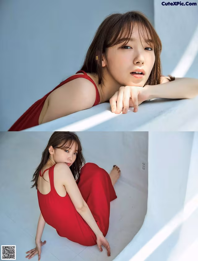 A woman in a red dress leaning against a wall.