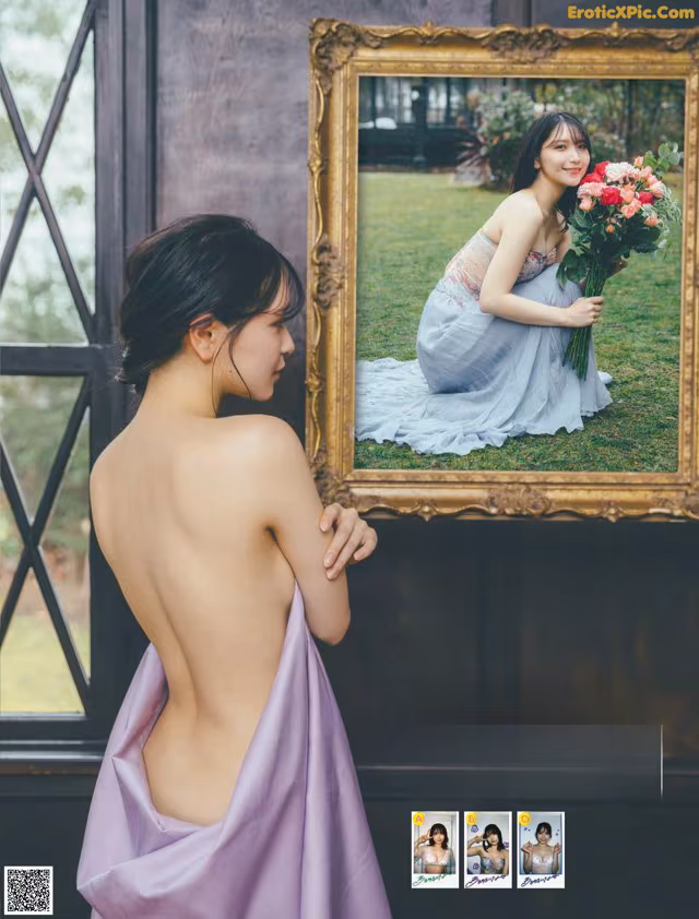 A woman in a purple dress holding a bouquet of flowers.