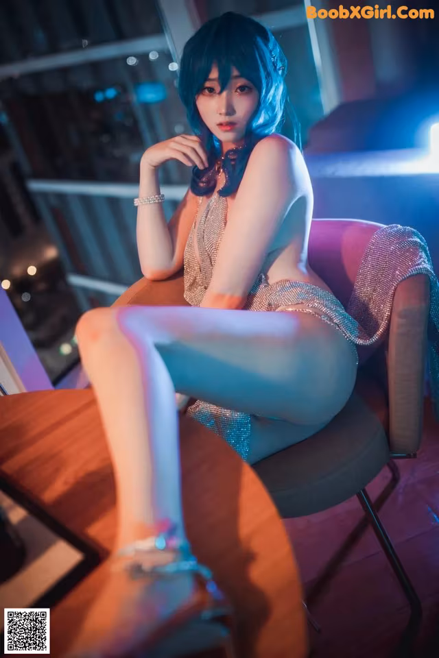 A woman sitting on a chair in a room.